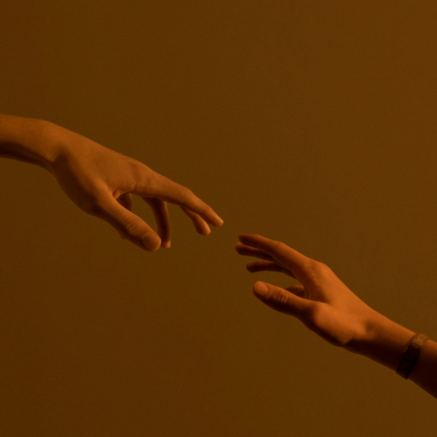 Two hands reaching toward each other